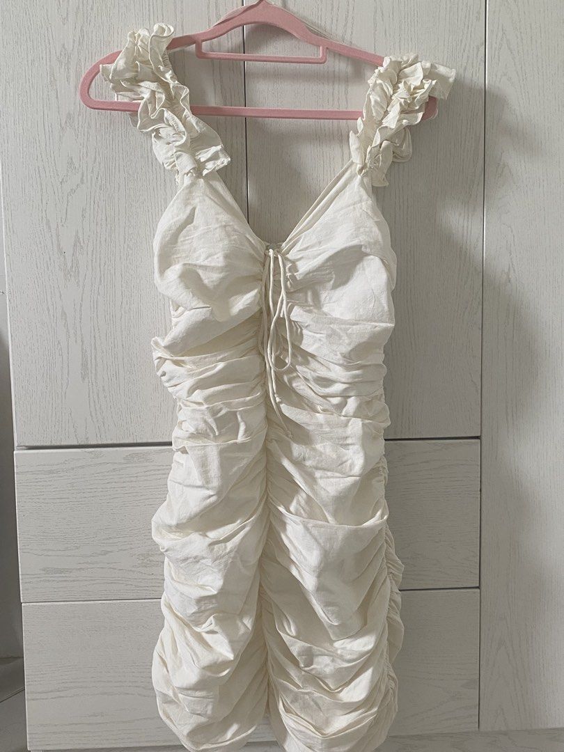 Zara White Ruched Ruffle Strap Mini Dress (Category: Dresses) located in Cebu City. Submitted by declairetter (Listing ID 1454646601, Image 1). Description: - Cute white mini dress - Ruched body for a flattering fit - Adorable ruffle straps - Adjustable drawstring detail at the bust - Ideal for a night out or special occasion.