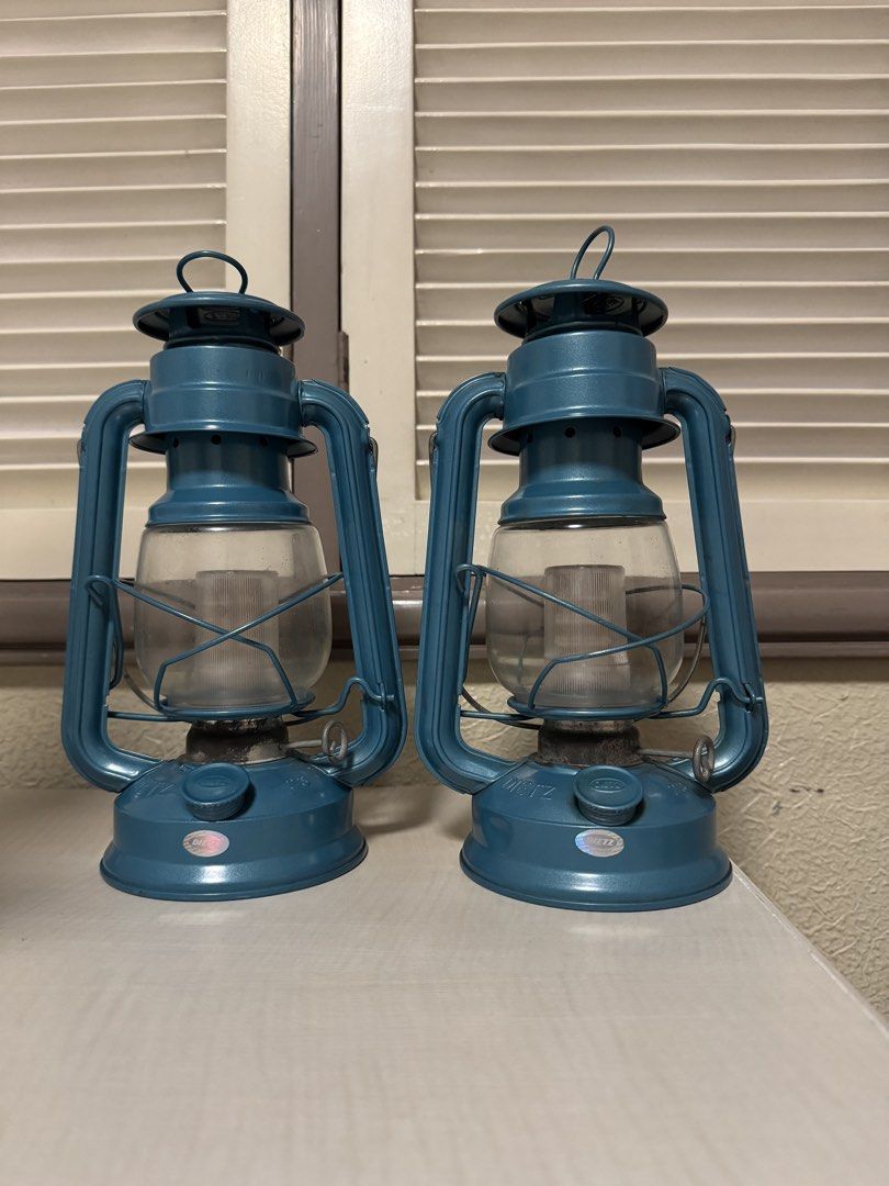 2x DIETZ Lanterns - Battery Operated (Category: Lighting) located in Makati City. Submitted by avic_c (Listing ID 1458899335, Image 2). Description: Matching pair of DIETZ lanterns in a striking vintage blue/teal finish. DIETZ branding is embossed on the lanterns, with “23” marking. Both come with glass globes. Cover for batteries missing. Good display condition with age-related wear, patina and some oxidation around the burner areas. Glass appea