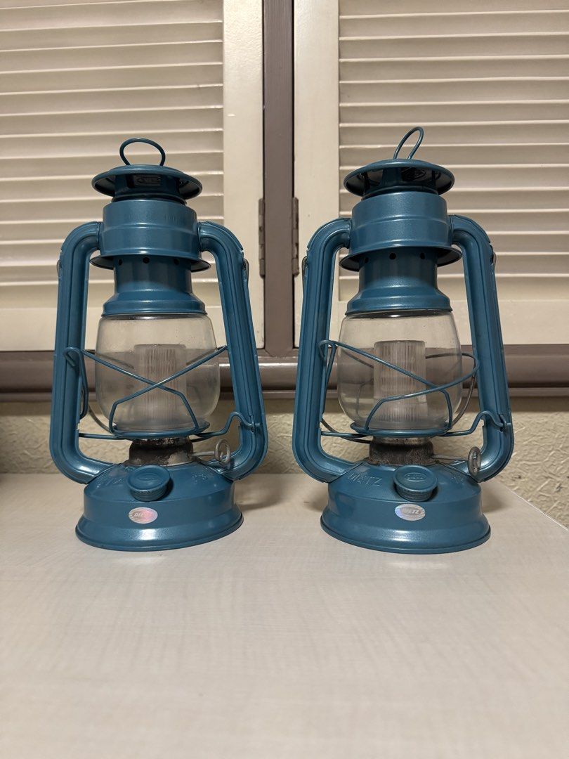 2x DIETZ Lanterns - Battery Operated (Category: Lighting) located in Makati City. Submitted by avic_c (Listing ID 1458899335, Image 1). Description: Matching pair of DIETZ lanterns in a striking vintage blue/teal finish. DIETZ branding is embossed on the lanterns, with “23” marking. Both come with glass globes. Cover for batteries missing. Good display condition with age-related wear, patina and some oxidation around the burner areas. Glass appea