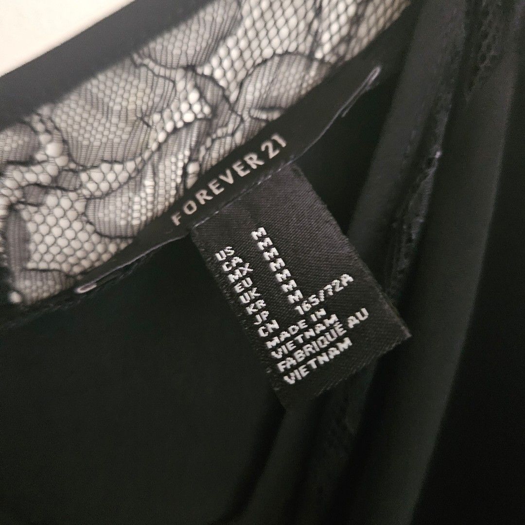 9. Forever 21 Black Lace Trim Jumpsuit Medium (Category: Jumpsuits) located in San Juan City. Submitted by titaofmanilaessentials (Listing ID 1458907423, Image 3). Description: - Forever 21 Black Jumpsuit - Size: M - Thin spaghetti straps - Lace trim along neckline - Elasticated waist for comfort - Versatile: Great for night outs or casual wear - Origin: Made in Vietnam - Has damage on the Lace part near the arm. Can easily be sewn back. - RFS: T