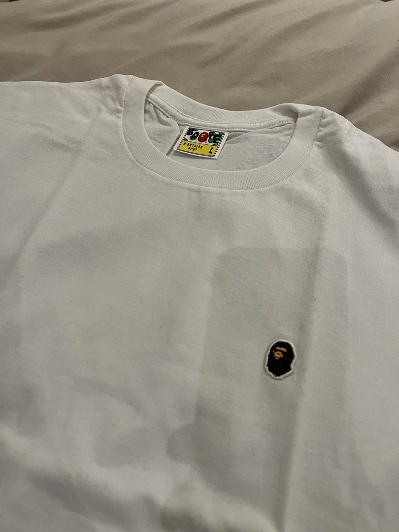 BAPE One Point Tee Size L (Category: Tshirts & Polo Shirts ) located in Quezon City. Submitted by shopsecondfits (Listing ID 1459034623, Image 1). Description: Has yellow stains due to storage SRP: P8700 - White BAPE T-shirt - Features iconic ape head graphic - Comes in original packaging - Size: Large (L) - Ideal for streetwear enthusiasts - A classic piece to add to your collection.