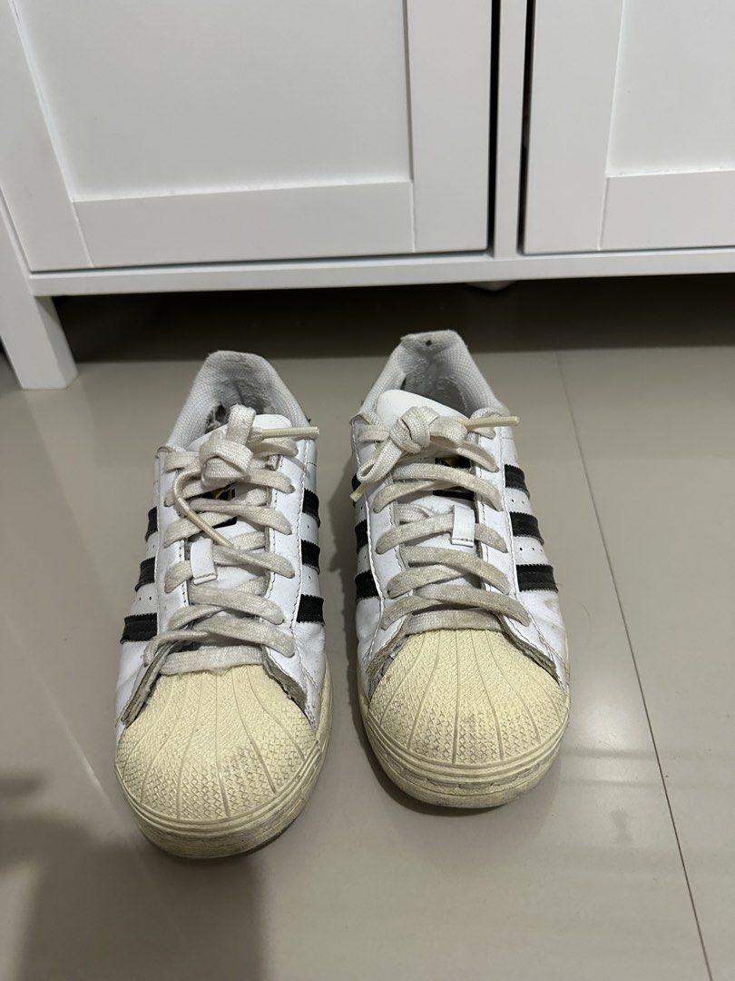 Adidas Superstar White Black Stripes Shell Toe Sneakers (Category: Sneakers) located in Davao. Submitted by wise.chin88 (Listing ID 1459005112, Image 1). Description: - Classic Adidas Superstar sneakers - White with iconic black stripes - Features the signature shell toe - Laces are slightly worn - Soles show some dirt and scuffing - Still a great pair for everyday wear - Grab these timeless kicks!.