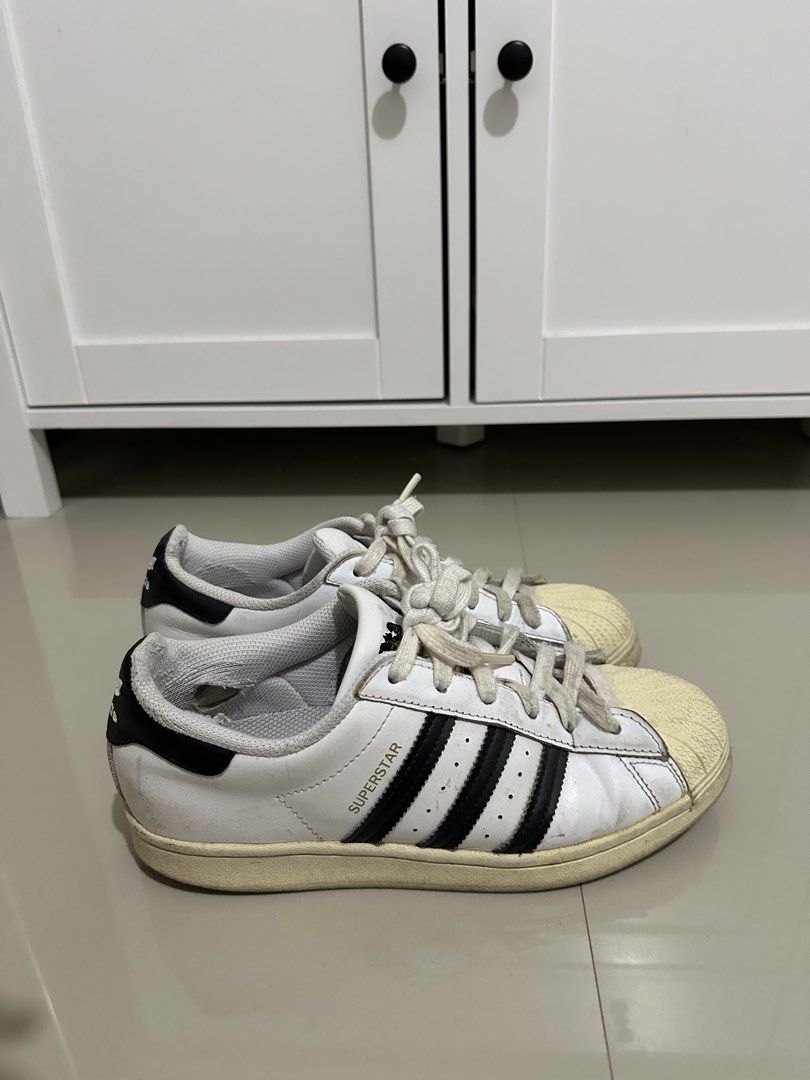 Adidas Superstar White Black Stripes Shell Toe Sneakers (Category: Sneakers) located in Davao. Submitted by wise.chin88 (Listing ID 1459005112, Image 2). Description: - Classic Adidas Superstar sneakers - White with iconic black stripes - Features the signature shell toe - Laces are slightly worn - Soles show some dirt and scuffing - Still a great pair for everyday wear - Grab these timeless kicks!.