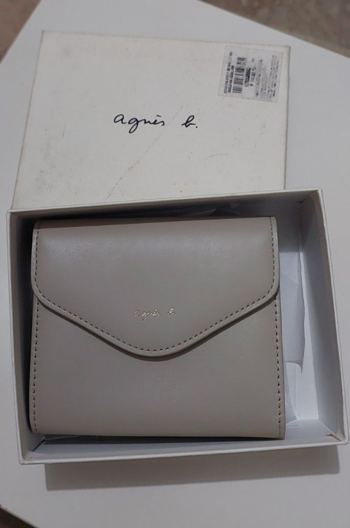 agnès b. Ava Leather Bi-fold Wallet (Category: Luxury Bags & Wallets) located in Manila. Submitted by deqluttering (Listing ID 1459002666, Image 1). Description: - Agnes B. bi-fold wallet - Made of genuine leather - Color: nude/taupe - Includes original box and tags, box have dirt marks but intact - Small and compact design - Ideal for everyday use and small bags.