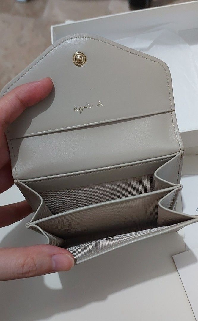 agnès b. Ava Leather Bi-fold Wallet (Category: Luxury Bags & Wallets) located in Manila. Submitted by deqluttering (Listing ID 1459002666, Image 3). Description: - Agnes B. bi-fold wallet - Made of genuine leather - Color: nude/taupe - Includes original box and tags, box have dirt marks but intact - Small and compact design - Ideal for everyday use and small bags.