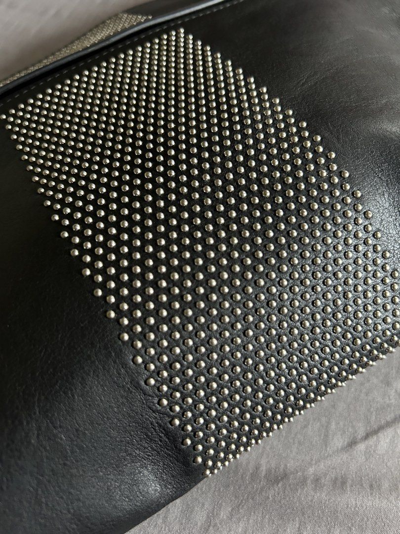 (Authentic) Alexander McQueen Black Leather Studded Clutch (Category: Luxury Bags & Wallets) located in Carigara. Submitted by abiealberca (Listing ID 1458934601, Image 2). Description: - Authentic Alexander McQueen clutch - Genuine black leather (Calf Skin) - Striking silver stud detailing in a striped pattern - Secure skull zipper closure with branded pull tab - Interior label confirms 'Made in Italy' and date code - Comes with original dust ba