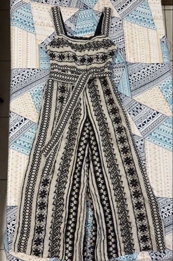 Alice + Olivia Black & White Patterned Jumpsuit Size 2 (Category: Jumpsuits) located in Makati City. Submitted by bibas.corner (Listing ID 1459045764, Image 3). Description: - Alice + Olivia jumpsuit - Black and white geometric pattern - Square neckline with lace trim - Belted waist - Wide leg cropped pants - Side pockets - Ideal for day outs or casual events - Comfortable and stylish.
