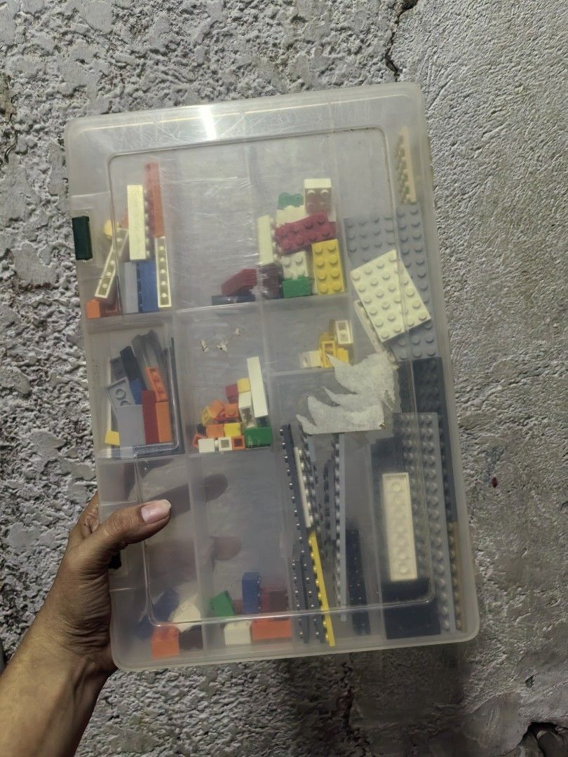 Assorted Lego Bricks in Storage Container (Category: Lego & Building Sets) located in Paranaque City. Submitted by furugiyafinds (Listing ID 1458900694, Image 1). Description: - Assorted Lego bricks - Various colors and sizes - Includes clear plastic storage container with multiple compartments - Ideal for building and creative play - Plenty of pieces for hours of fun.