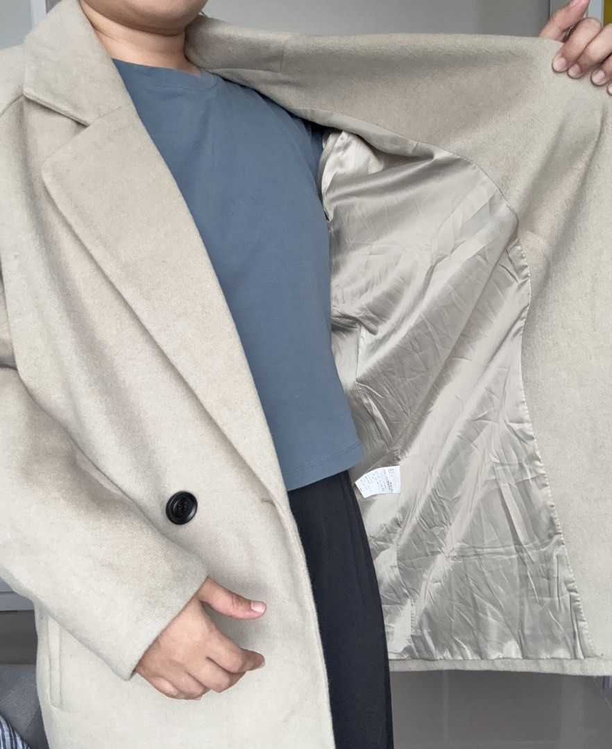Beige Wool Blend Double Breasted Coat Size Large with full inner lining (Category: Coats, Jackets and Outerwear) located in Quezon City. Submitted by springdreamph (Listing ID 1459025602, Image 3). Description: - Beige (green undertone) double-breasted coat - Brand: TOPFEELING - Material: Wool blend polyester fabric - Full inner lining - Features: Two front pockets, button closure - Thick fabric - Ideal for: 10 degrees and below - Styling: Versat