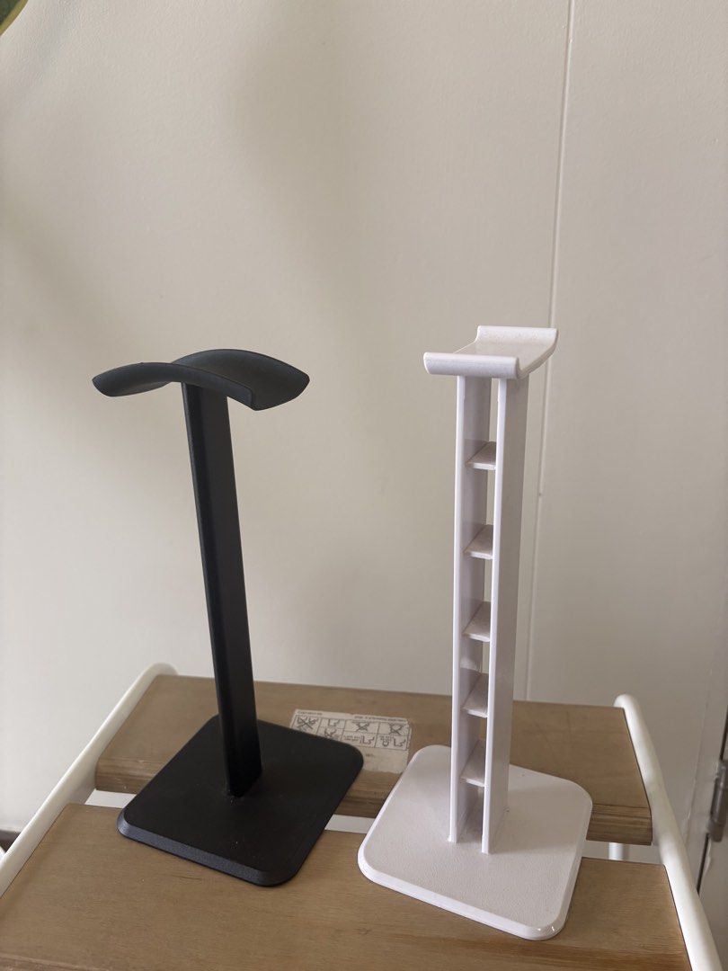 Black and White Headphone Stand Set (Category: Headphones & Headsets) located in Manila. Submitted by patricialyanna97 (Listing ID 1458942464, Image 1). Description: - Set of 2 headphone stands: 1 black, 1 white. - Sturdy base and curved top for secure headphone placement. - Perfect for organizing your desk space. - Keeps your headphones safe and easily accessible..