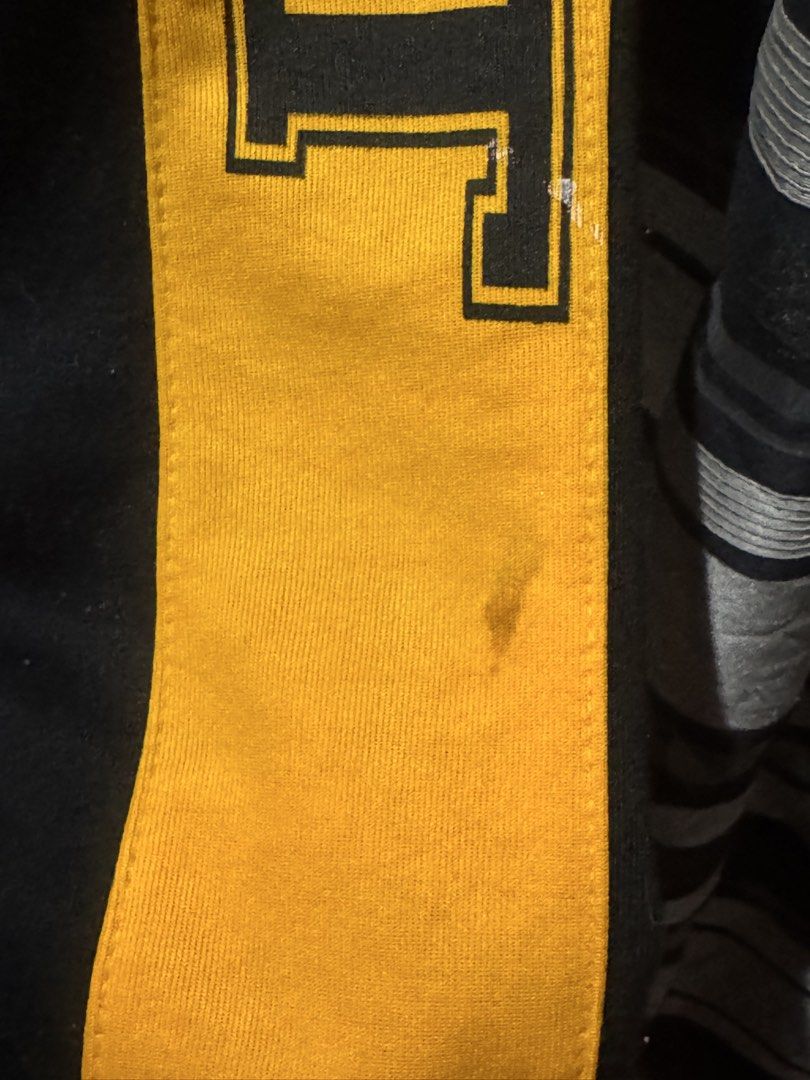 Black and Yellow UST Track Pants (Category: Other Bottoms) located in Caloocan City. Submitted by mariajuanaxxviii (Listing ID 1458891636, Image 2). Description: - Black track pants - Yellow stripes on sides - 'UST' lettering on right leg - 'SHS' lettering on left leg - Elastic waistband with drawstring - Small stain on right leg's yellow stripe - Suitable for casual wear or sports.