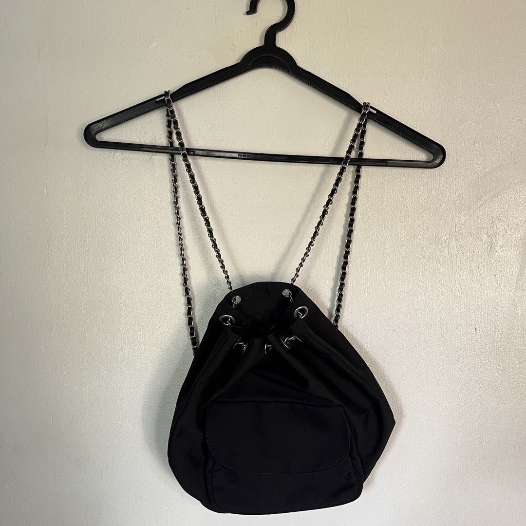 Black Drawstring Backpack with Chain Straps (Category: Backpacks) located in Las Pinas. Submitted by solfits (Listing ID 1458899643, Image 1). Description: - Chic black drawstring backpack - Convenient front pocket for quick access - Edgy metal chain straps - Ideal for carrying your daily essentials - Versatile for everyday use - Has two pockets inside.