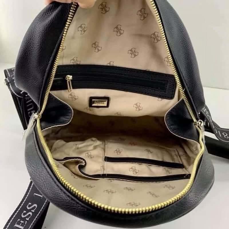 Black G Backpack with "Love Guess" Print (Category: Backpacks) located in Makati City. Submitted by nixxx000 (Listing ID 1458905235, Image 3). Description: - Stylish black Guess backpack - Features iconic 'Love Guess' print on the front - Convenient front zip pocket for quick access - Spacious main compartment with internal pockets for organization - Adjustable shoulder straps with 'Guess 1981' branding - Elegant gold-tone hardware - Ideal for ev