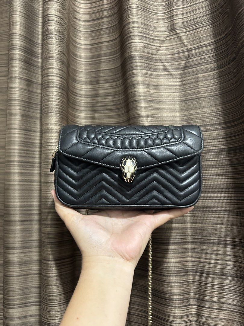 Black Quilted Chevron Shoulder Bag with Snake Clasp (Category: Luxury Bags & Wallets) located in Tacloban City. Submitted by houseofluxury.co (Listing ID 1458932859, Image 1). Description: - Authentic Bvlgari Black quilted shoulder bag - Elegant chevron pattern - Gold chain strap - Unique snake head clasp closure - Two zippered side compartments - Ideal for carrying daily essentials.