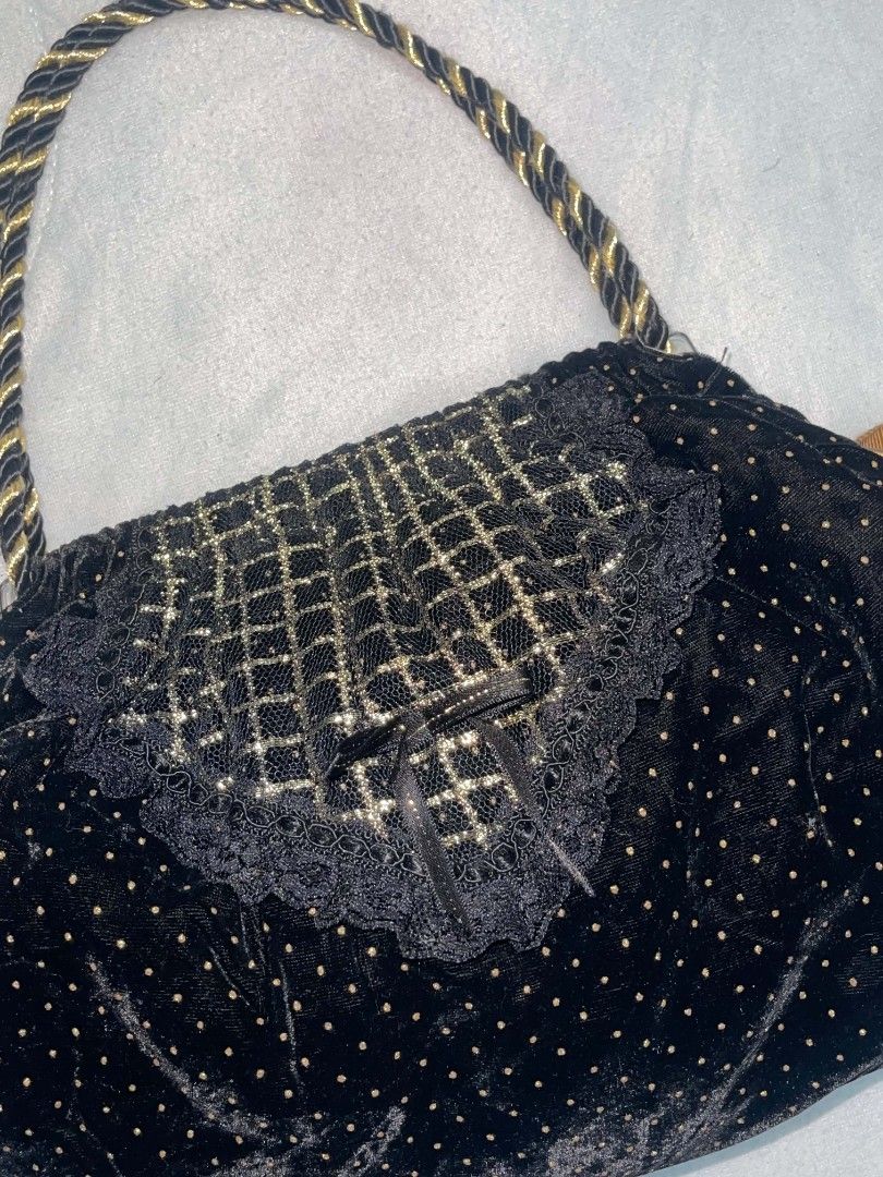 Black Velvet Beaded Drawstring Handbag with Gold Rope Handle (Category: Purses & Pouches) located in Binan City. Submitted by myks_thrift (Listing ID 1458966839, Image 2). Description: - Chic black velvet handbag with charming gold polka dots. - Elegant beaded lace detail on the front flap. - Stylish gold rope handle for comfortable carrying. - Secure drawstring closure with decorative gold ribbon ties. - Compact size, ideal as a clutch or evenin
