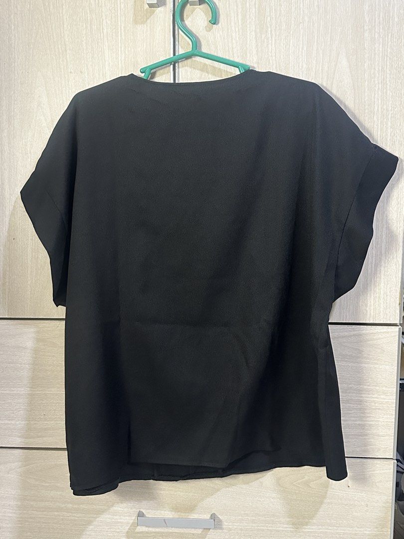 Black V-Neck Short Sleeve Top (Category: Blouses) located in Taguig. Submitted by ibsss (Listing ID 1459044827, Image 2). Description: - Simple black V-neck top - Short sleeves with cuffed hem - Nice fabric drape - Versatile: dress up or down - Easy to pair with skirts or pants - Great for casual outings or work Size: 120cm bust.