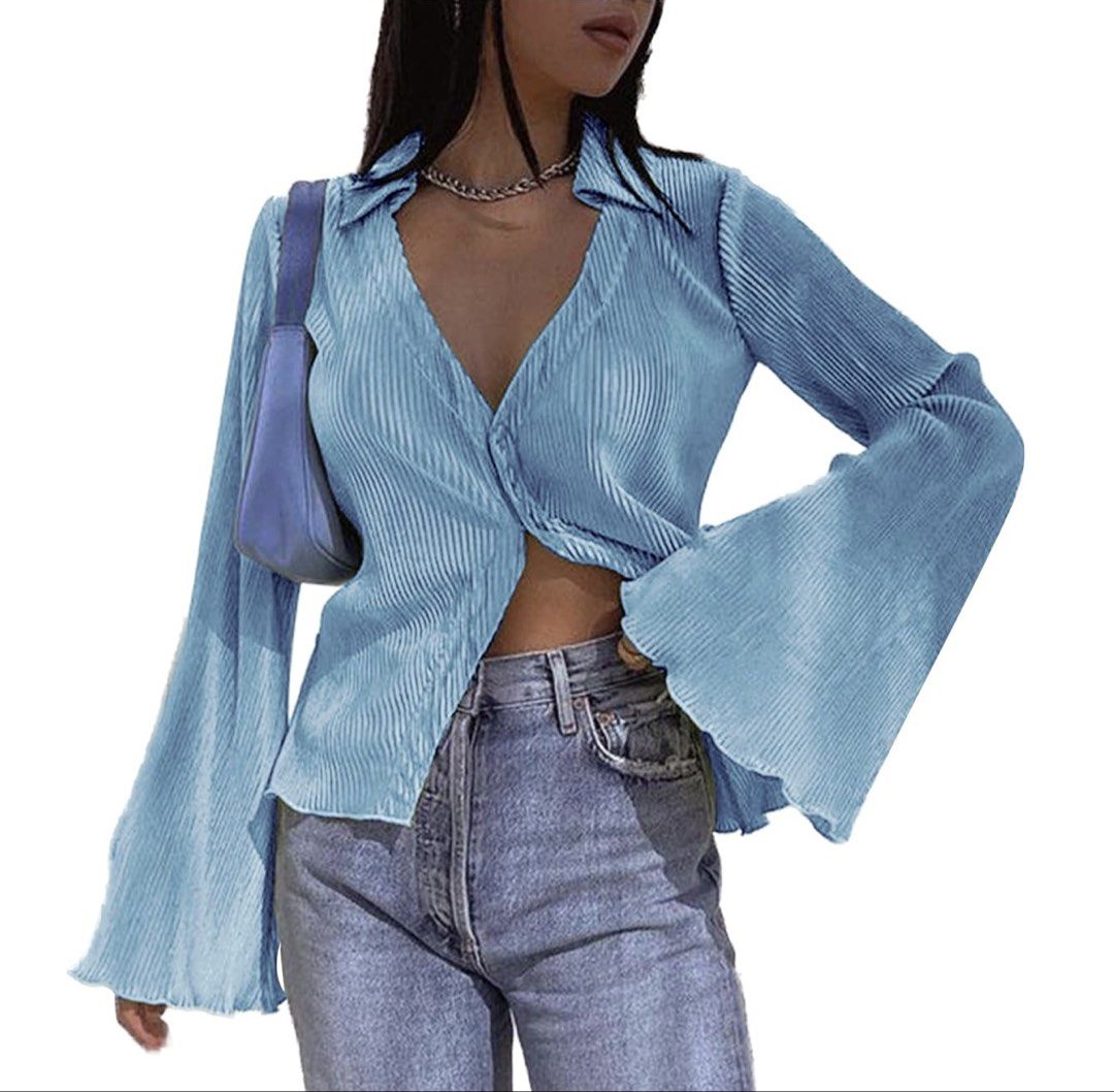 Blue Pleated Bell Sleeve Button Up Shirt (Category: Tshirts & Polo Shirts ) located in Mandaluyong City. Submitted by hopeworldplane (Listing ID 1458990789, Image 1). Description: - Light blue pleated shirt - Long bell sleeves - Button-up front with collar - Versatile styling: tuck in, wear open - Ideal for night out or casual wear - Flowy and stylish design.