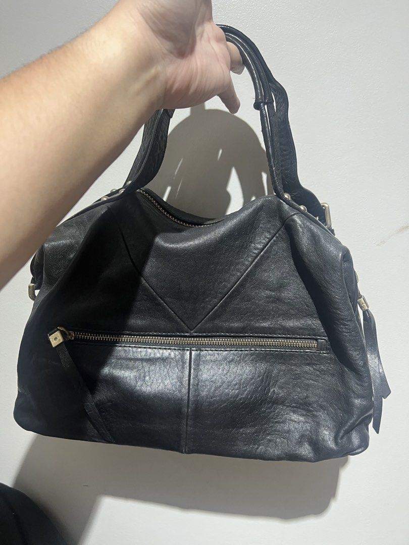 Breal Black Leather Shoulder Bag (Category: Shoulder Bags) located in Santa Rosa. Submitted by pepperchill (Listing ID 1459068427, Image 2). Description: - Genuine black leather with a stylish textured finish. - Convenient front zip pocket for quick access. - Secure top zip closure to keep your belongings safe. - Comfortable double shoulder straps. - Elegant gold-tone hardware details. - Ample interior space for all your essentials. - Your perfec