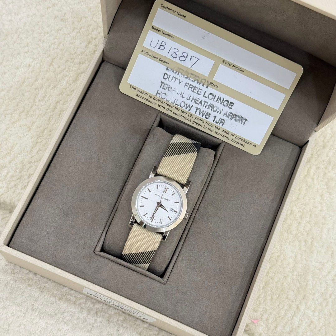 Burberry Watch with Classic Check Strap (Category: Luxury Watches) located in San Leonardo. Submitted by iluvkopiii (Listing ID 1458922833, Image 2). Description: Burberry Swiss Made Quartz Watch featuring the iconic Nova Check textile strap and a classic silver dial. Complete with original box and authenticity card. ₱15,000 only.