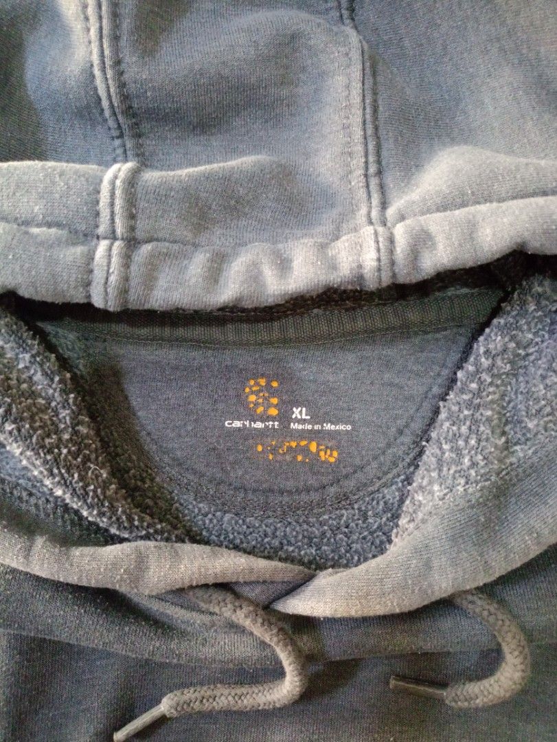 Carhartt Grey Pullover Hoodie Sweatshirt XL (Category: Coats, Jackets and Outerwear) located in Caloocan City. Submitted by grandturtle-371b8d (Listing ID 1458903190, Image 3). Description: - Grey Carhartt Hoodie - Size: XL - Material: Cotton and Polyester Blend - Style: Classic pullover with front pocket and drawstring hood - Condition: Great for everyday wear.