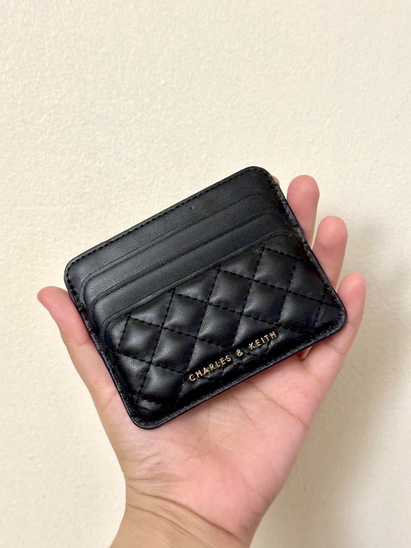Charles & Keith Black Quilted Card Holder (Category: Wallets & Card holders) located in Makati City. Submitted by allaissx (Listing ID 1459035216, Image 1). Description: - Authentic black quilted card holder by Charles & Keith - Total of 7 pockets (3 for each side, 1 middle pocket) - Issue: some dents. overall condition is 8/10. .