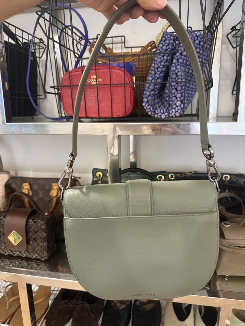 Genuine Leather Gabine Shoulder Bag (Category: Shoulder Bags) located in San Juan City. Submitted by dyclutter (Listing ID 1458913860, Image 3). Description: - Authentic (SRP php 8,500) Model: Gabine Genuine Leather Sage green shoulder bag Comes with a long strap also - Chic half-moon silhouette - Front flap with elegant buckle detail - Polished silver hardware - Interior zip pocket for essentials - Adjustable strap for comfortable wear - Ideal f