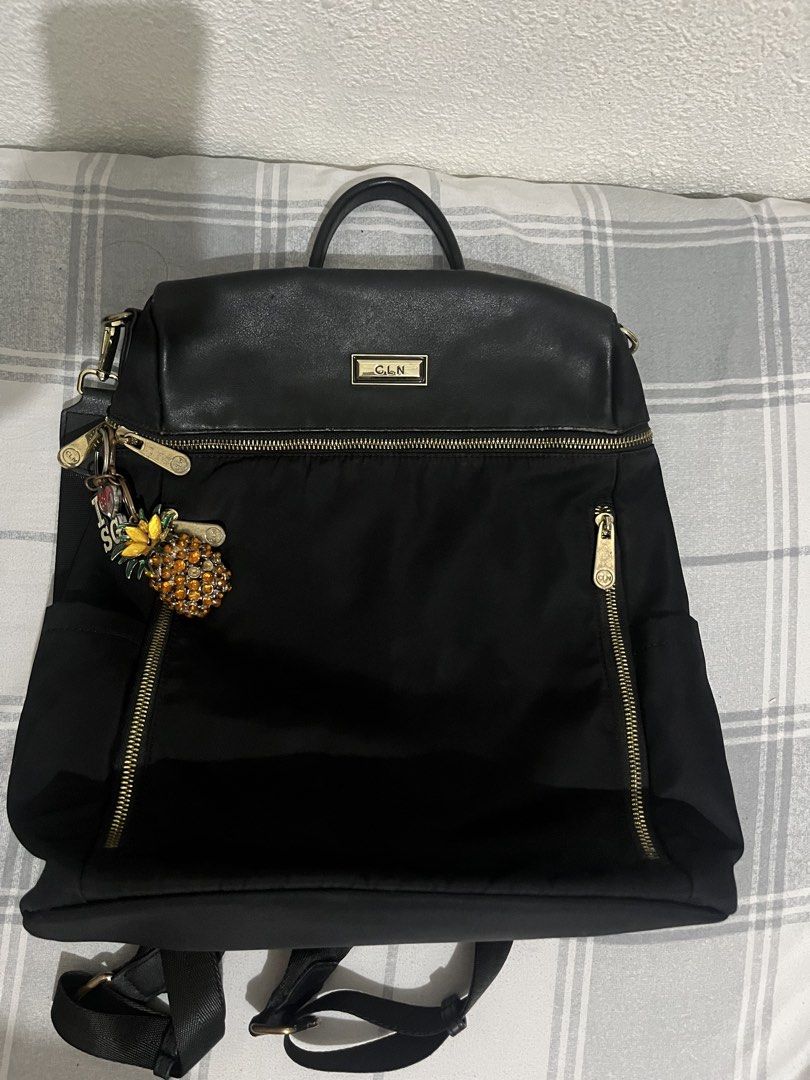 CLN Black Nylon and Leather Backpack with Charm (Category: Backpacks) located in Manila. Submitted by fionanicolas (Listing ID 1459006938, Image 1). Description: - Brand: CLN - Color: Black - Material: Nylon with Leather Details - Features: Top handle, adjustable shoulder straps, front zipper pockets - Hardware: Gold - Extra: Comes with a cute pineapple charm.
