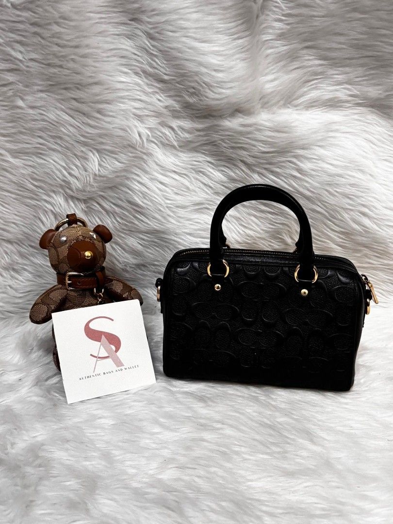 Coach Black Embossed Monogram Leather Mini Rowan (Category: Luxury Bags & Wallets) located in Manila. Submitted by seresa_04 (Listing ID 1458902705, Image 3). Description: - Authentic Coach mini barrel bag - Black leather with all-over embossed monogram pattern - Gold hardware and zipper - Top handles - Detachable crossbody strap - Lined interior - Compact size, perfect for essentials - Comes with a cute bear charm.