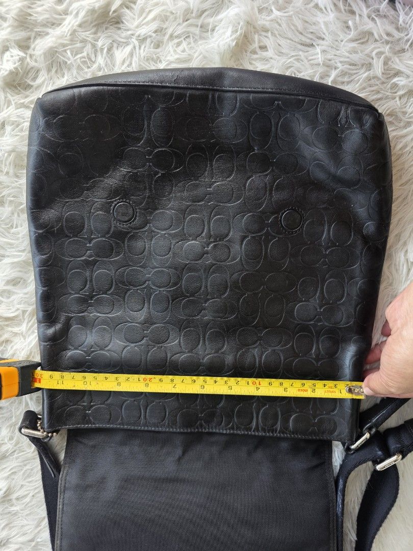 Coach Black Leather Embossed Monogram Messenger Crossbody Bag (Category: Cross-body Bags) located in Lemery. Submitted by venus23 (Listing ID 1458940983, Image 3). Description: - Coach black leather crossbody bag - Features signature C monogram embossed all over - Front flap with zippered pocket - Spacious main compartment - Adjustable strap for comfortable wear - Ideal for everyday use - Approximate dimensions: 10" wide x 11" tall.