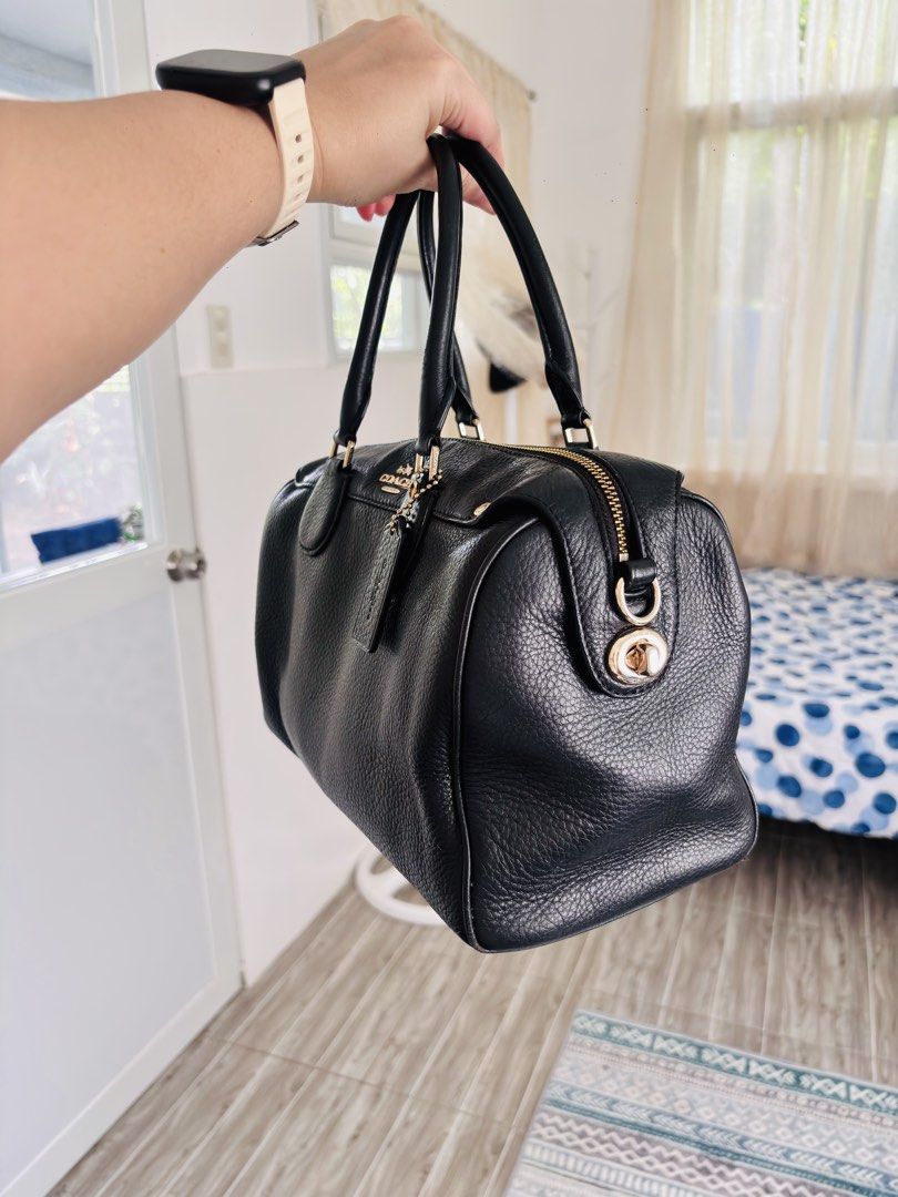 Coach Black Leather Satchel Bag (Category: Luxury Bags & Wallets) located in Quezon City. Submitted by itsmeriaa (Listing ID 1458903419, Image 2). Description: - Classic black Coach satchel - Pebbled leather exterior - Gold hardware details - Top handles and zip closure - Interior zip and slip pockets - Comes with Coach leather tag - Ideal for everyday use.