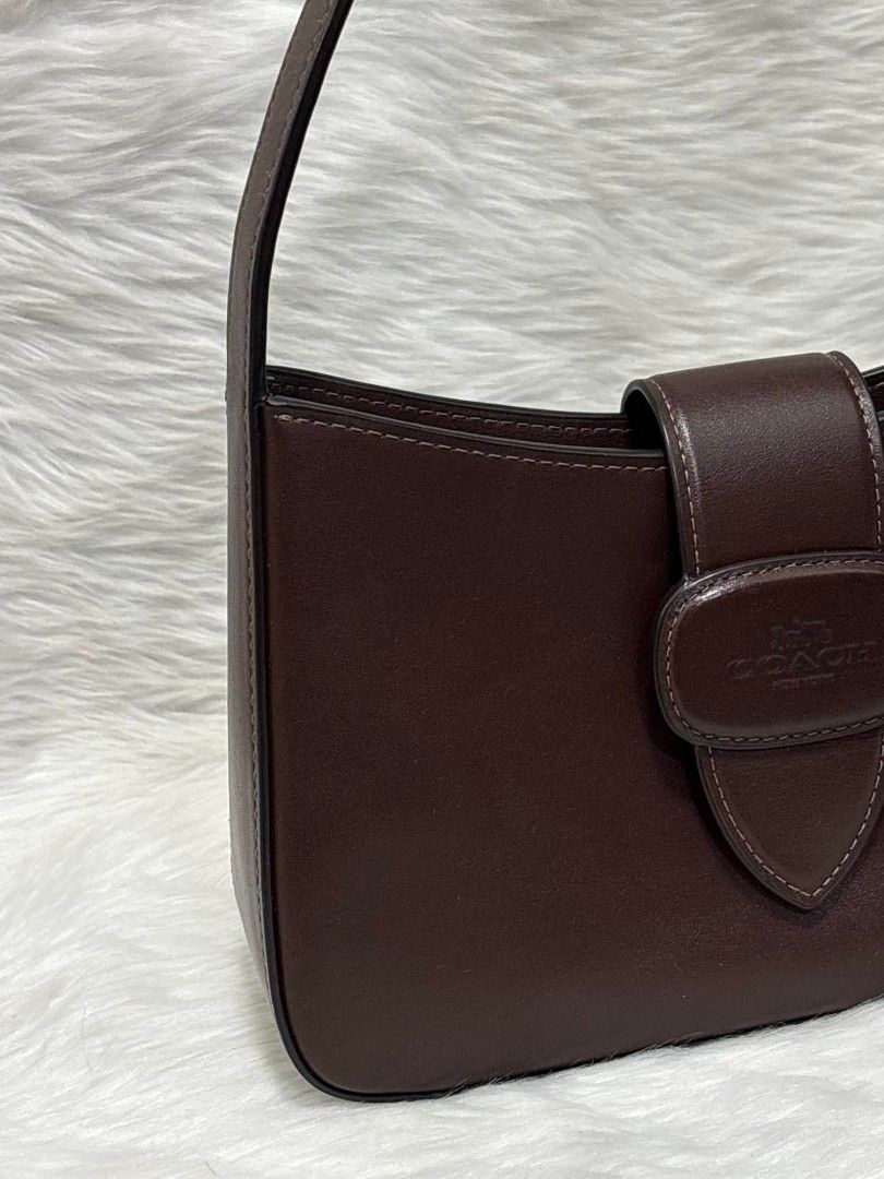 Coach Eliza Shoulder Bag (Brown) (Category: Luxury Bags & Wallets) located in Manila. Submitted by seresa_04 (Listing ID 1458902704, Image 2). Description: - Classic brown leather shoulder bag by Coach - Simple and chic design - Interior zippered pocket - Adjustable strap for comfort - Ideal for everyday use - Perfectly fits your essentials.