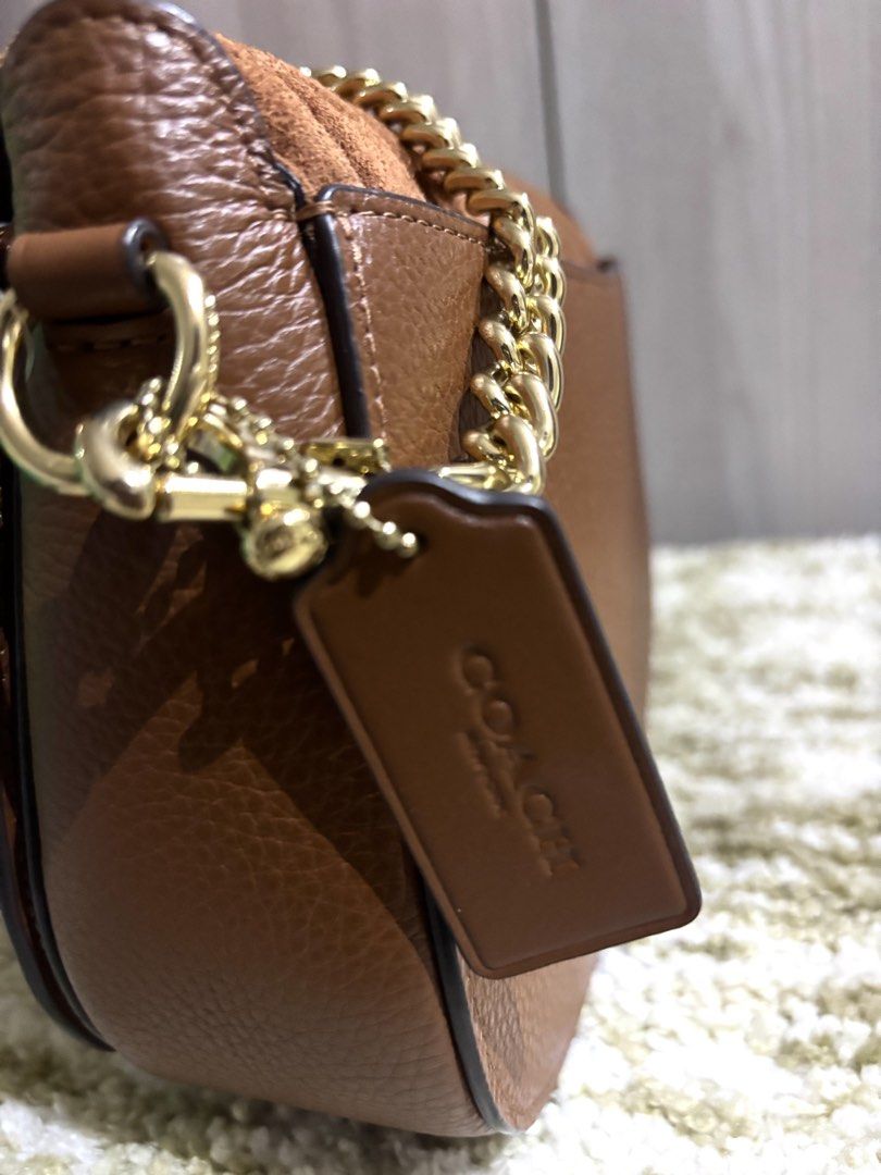 Coach Georgie Saddle Bag with Linear Quilting (Category: Luxury Bags & Wallets) located in Manila. Submitted by ourcams0701 (Listing ID 1459022157, Image 3). Description: - Bought for 26k -No dustbag - Brown Coach shoulder bag - Mix of suede and pebbled leather - Gold chain strap - Classic Coach horse and carriage logo - Comes with a Coach leather tag - Versatile for everyday or evening wear.