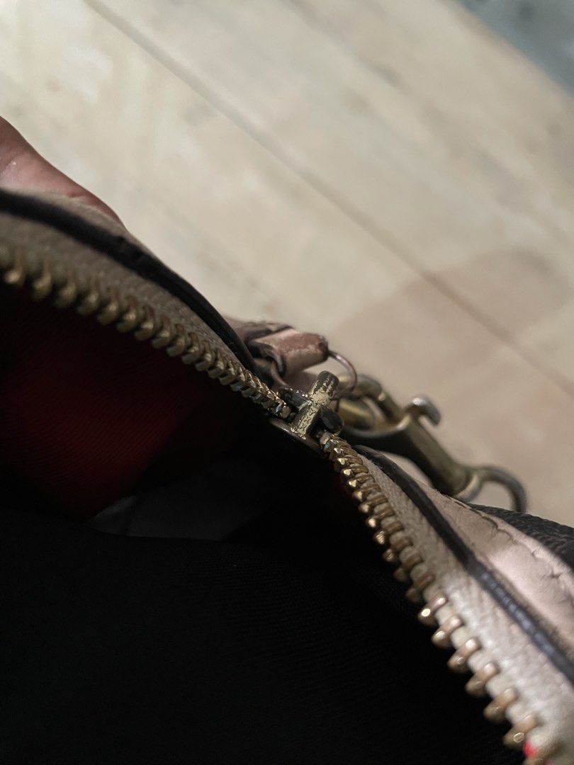 Coach Monogram Speedy Bag with Red Stripe (Category: Luxury Bags & Wallets) located in Buenavista. Submitted by ivoperez27 (Listing ID 1459004126, Image 3). Description: - Authentic brown Coach monogram speedy bag - Eye-catching red and white stripe detail on the front - Classic beige leather trim and handles - Vibrant red interior lining - Secure zipper closure - Comes with a detachable long strap for versatile wear - Minor signs of wear on the 