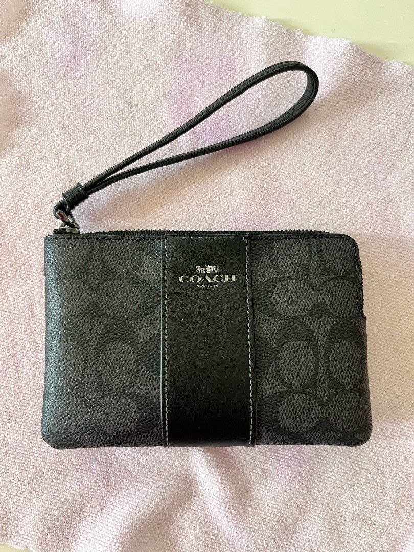 Coach Signature Canvas Wristlet Pouch (Category: Luxury Bags & Wallets) located in Taguig. Submitted by curatedlux (Listing ID 1458973185, Image 1). Description: - Authentic Coach wristlet bought from Premium Store Colorado USA - Classic black and grey signature print - Durable leather strap - Secure zipper closure - Interior card slots for organization - Ideal for carrying daily essentials.