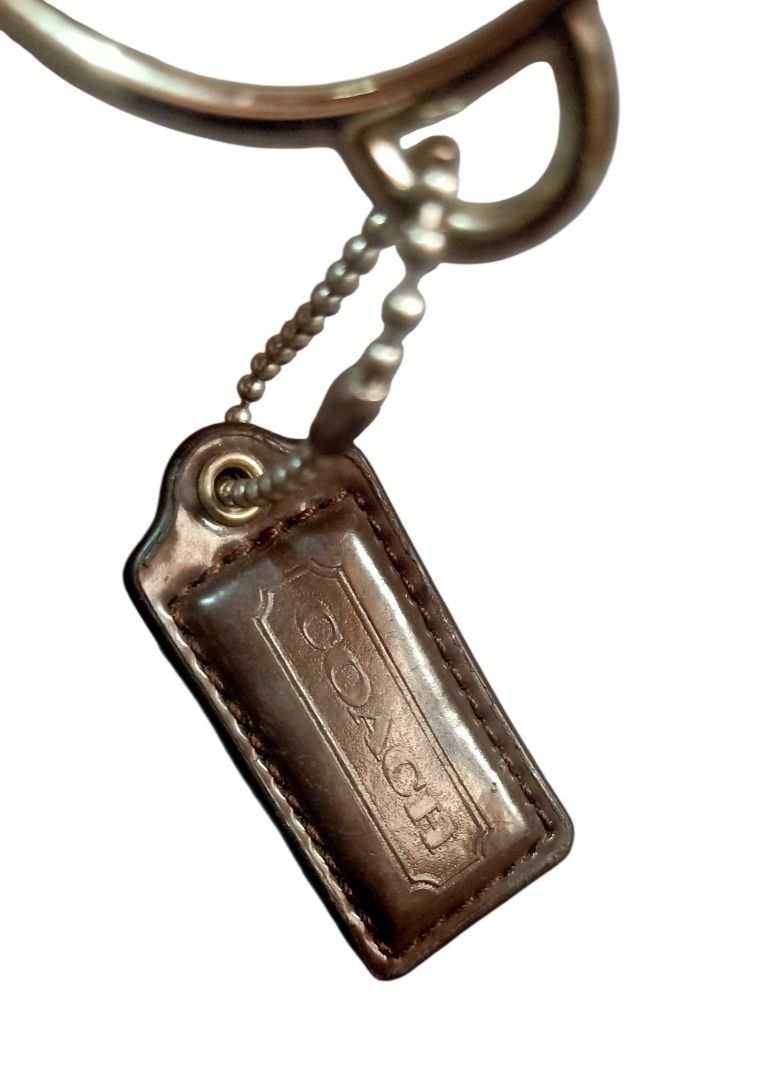 ⚜️Coach Silver Script Spellout Bag Charm & Leather Hang Tag (Category: Luxury Accessories) located in Manila. Submitted by 74_tiger (Listing ID 1458964743, Image 3). Description: Item: Coach Silver Script Spellout Bag Charm & Leather Hang Tag Condition: Lightly Used Material: Mixed 💯% Authentic Rare Finds Vintage Piece Unique Design Big Size Very Presentable & Eye Catching Perfect Accessory To Your Luxury Bags, Clutches & Wallets. Can Also Be Us