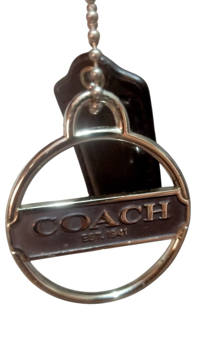 ⚜️Coach Silver Script Spellout Bag Charm & Leather Hang Tag (Category: Luxury Accessories) located in Manila. Submitted by 74_tiger (Listing ID 1458964743, Image 1). Description: Item: Coach Silver Script Spellout Bag Charm & Leather Hang Tag Condition: Lightly Used Material: Mixed 💯% Authentic Rare Finds Vintage Piece Unique Design Big Size Very Presentable & Eye Catching Perfect Accessory To Your Luxury Bags, Clutches & Wallets. Can Also Be Us