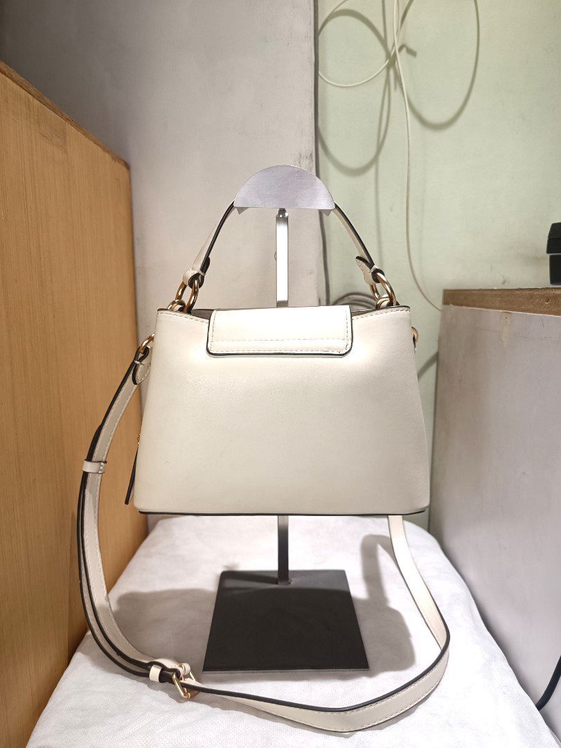 Coach small Top handle cross body bag (Category: Luxury Bags & Wallets) located in Makati City. Submitted by ja_23 (Listing ID 1458959385, Image 2). Description: Payment first---Shipping via lalamove/jnt(shouldered by the buyer) Personal Preloved Ivory color/Small size - Auth not guaranteed Minimal signs of use.