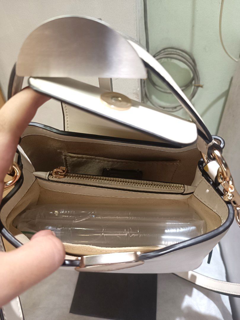 Coach small Top handle cross body bag (Category: Luxury Bags & Wallets) located in Makati City. Submitted by ja_23 (Listing ID 1458959385, Image 3). Description: Payment first---Shipping via lalamove/jnt(shouldered by the buyer) Personal Preloved Ivory color/Small size - Auth not guaranteed Minimal signs of use.