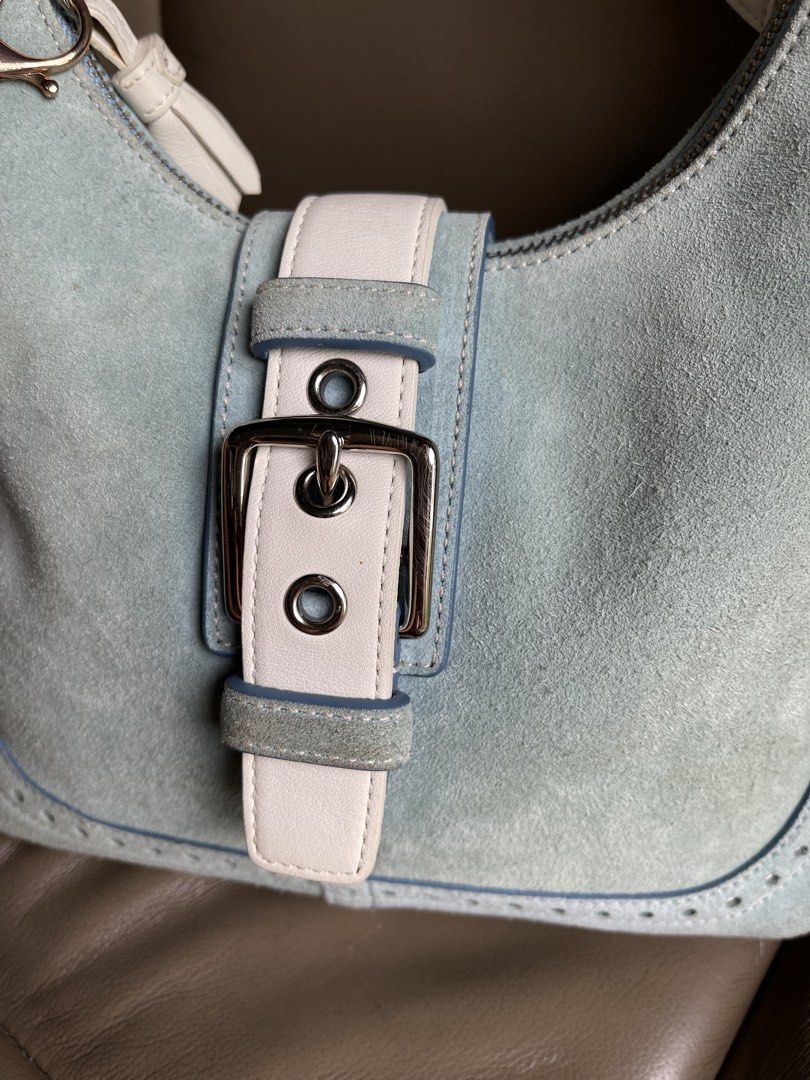 Coach Suede Hampton satchel Hobo Bag Light Blue (Category: Luxury Bags & Wallets) located in Dumaguete. Submitted by braveforest-2a12 (Listing ID 1458929993, Image 3). Description: - Light blue suede Coach hobo bag - White leather trim and buckle detail - Comes with original care booklet and cleaning kit - Adorable pearl and ribbon charm attached - Secure zipper closure - Ideal for everyday use.