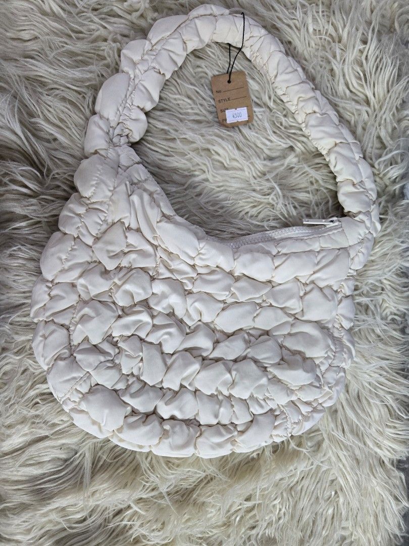 COS QUILTED mini bag (Category: Shoulder Bags) located in Quezon City. Submitted by bags4ever (Listing ID 1458962511, Image 1). Description: cos quilted mini - off-white or cream color. Frequently referred to as the "cloud bag" due to its distinct, pillowy textured quilting, this signature accessory features a secure zip closure and a soft top handle designed to sit comfortably on your shouldrs..