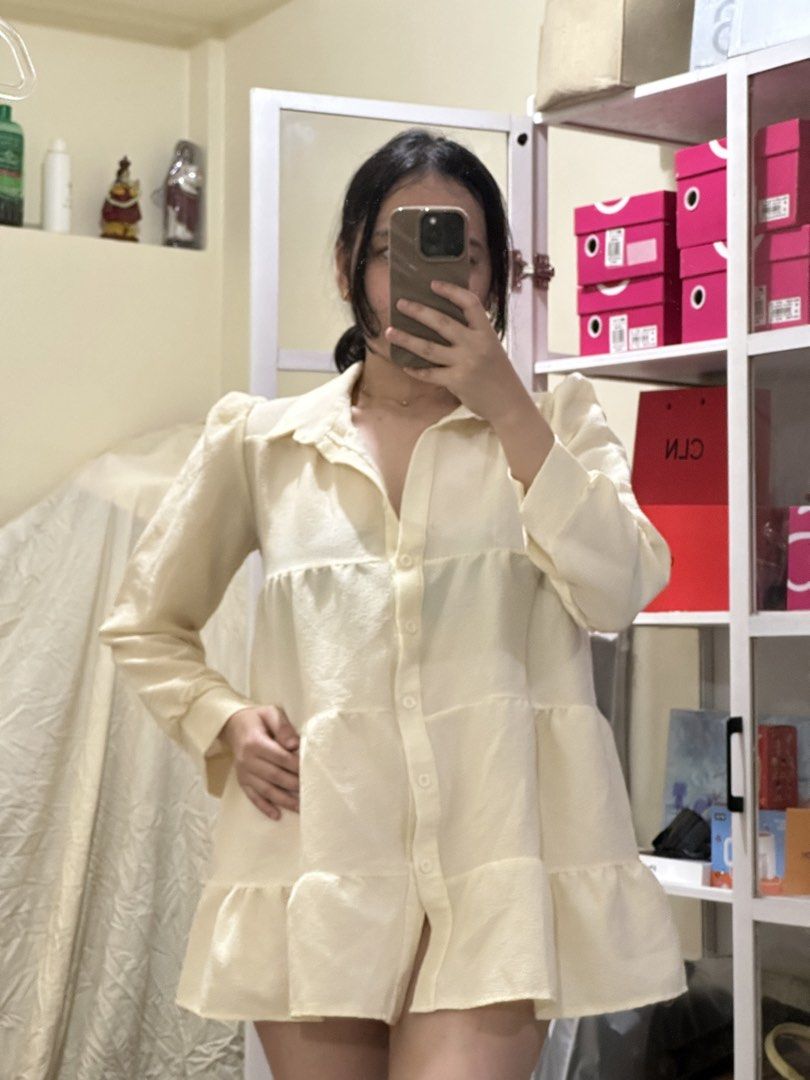 Cream Tiered Puff Sleeve Collared Button Down Mini Dress (Category: Dresses) located in Manila. Submitted by kathsclosetmnl (Listing ID 1459041008, Image 1). Description: - Cream colored mini dress - Collared neckline with button-down front - Puff sleeves for a stylish detail - Tiered design with ruffles at the hem - Versatile: wear alone or layered over shorts - Ideal for casual outings.