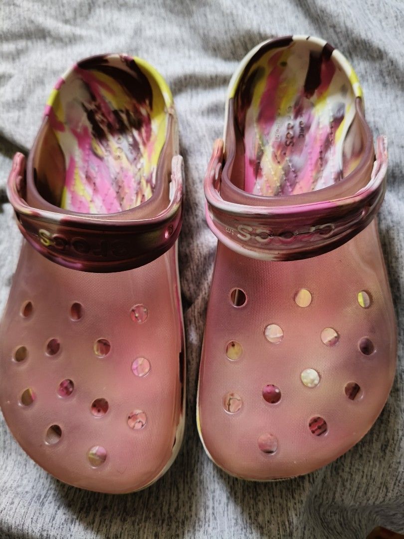 orig.crocs Classic Tie-Dye Clogs Pink Yellow Brown (Category: Slippers and slides) located in Marikina City. Submitted by lorence11 (Listing ID 1458968198, Image 1). Description: - Fun tie-dye Crocs clogs - Pink, yellow, and brown swirl pattern - Translucent pink exterior - Easy slip-on and off design - Ideal for casual wear or around the house.