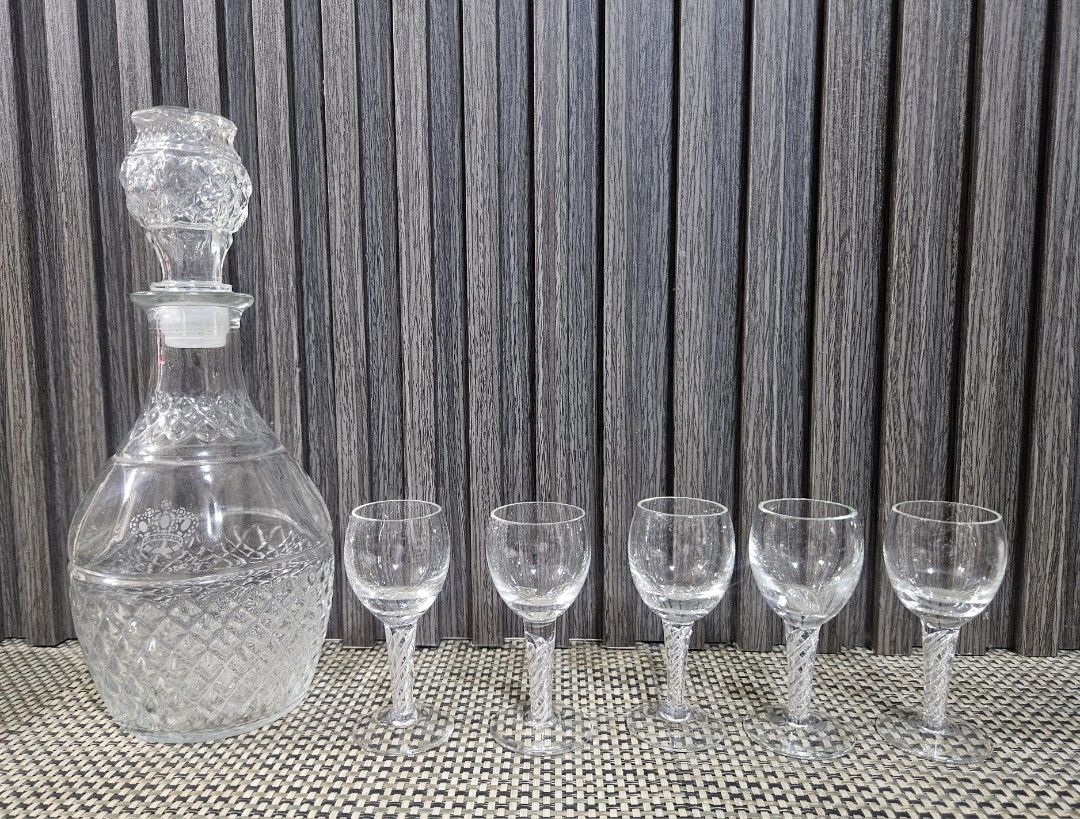Crystal Decanter and 5 Shot Glasses Set (Category: Other Kitchenware & Tableware) located in Rizal. Submitted by cherry_garcia (Listing ID 1458988793, Image 1). Description: - Vintage crystal decanter with stopper - Includes 5 matching shot glasses - Decanter features diamond-cut pattern at the base - Shot glasses have decorative twisted stems - Perfect for serving spirits or liqueurs - Adds a touch of elegance to any home bar setup.