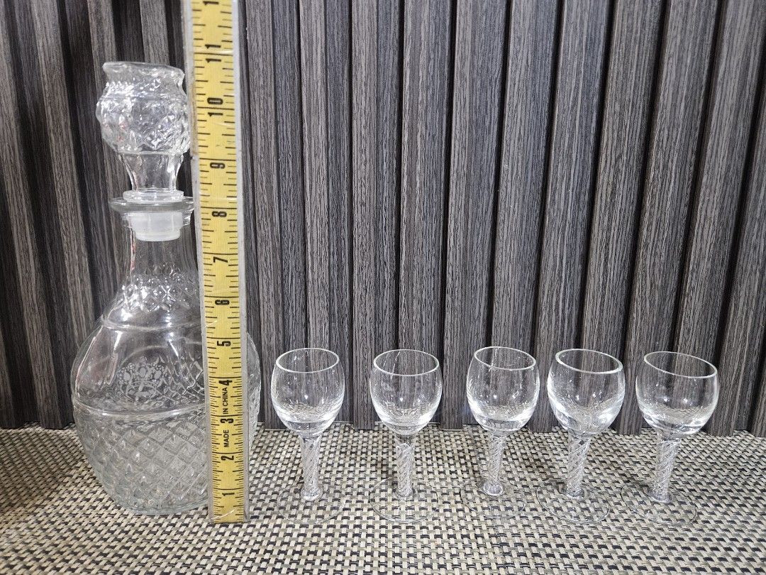 Crystal Decanter and 5 Shot Glasses Set (Category: Other Kitchenware & Tableware) located in Rizal. Submitted by cherry_garcia (Listing ID 1458988793, Image 2). Description: - Vintage crystal decanter with stopper - Includes 5 matching shot glasses - Decanter features diamond-cut pattern at the base - Shot glasses have decorative twisted stems - Perfect for serving spirits or liqueurs - Adds a touch of elegance to any home bar setup.