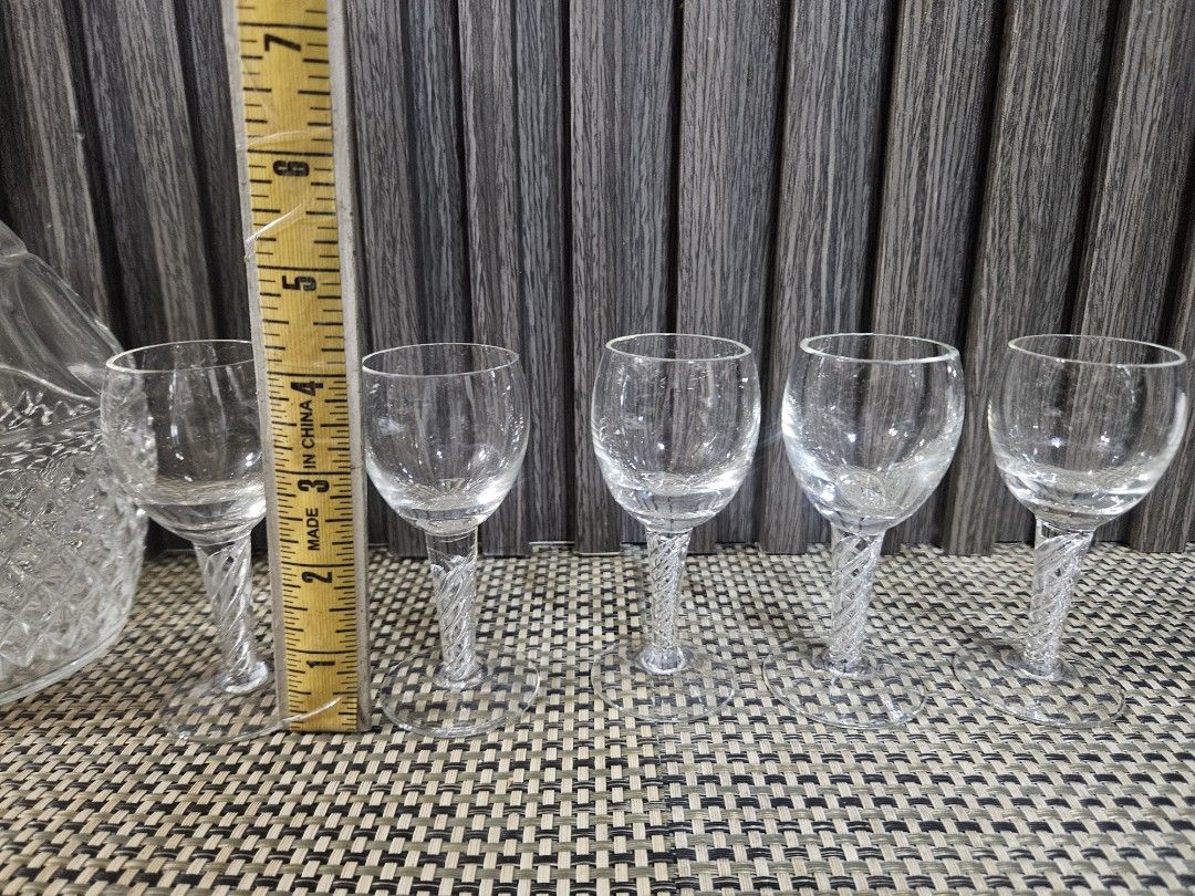 Crystal Decanter and 5 Shot Glasses Set (Category: Other Kitchenware & Tableware) located in Rizal. Submitted by cherry_garcia (Listing ID 1458988793, Image 3). Description: - Vintage crystal decanter with stopper - Includes 5 matching shot glasses - Decanter features diamond-cut pattern at the base - Shot glasses have decorative twisted stems - Perfect for serving spirits or liqueurs - Adds a touch of elegance to any home bar setup.