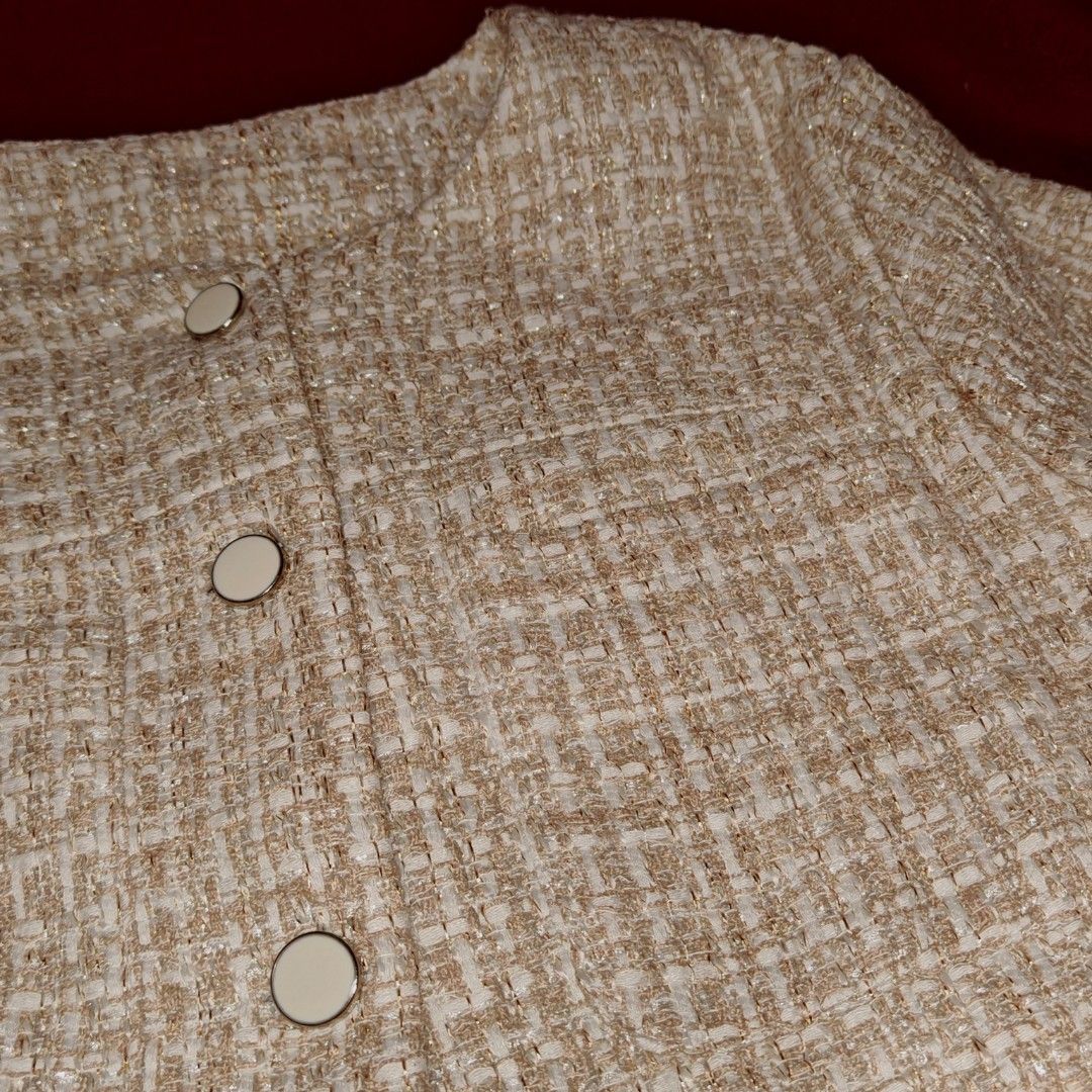 Dazy Tweed Cropped Jacket Size S (Category: Coats, Jackets and Outerwear) located in San Fernando. Submitted by decluttwv (Listing ID 1459040242, Image 2). Description: - Elegant cream and gold tweed cropped jacket - Short sleeves - Button front closure - Two small chest pockets - Made of 100% polyester - Versatile for layering or wearing solo.