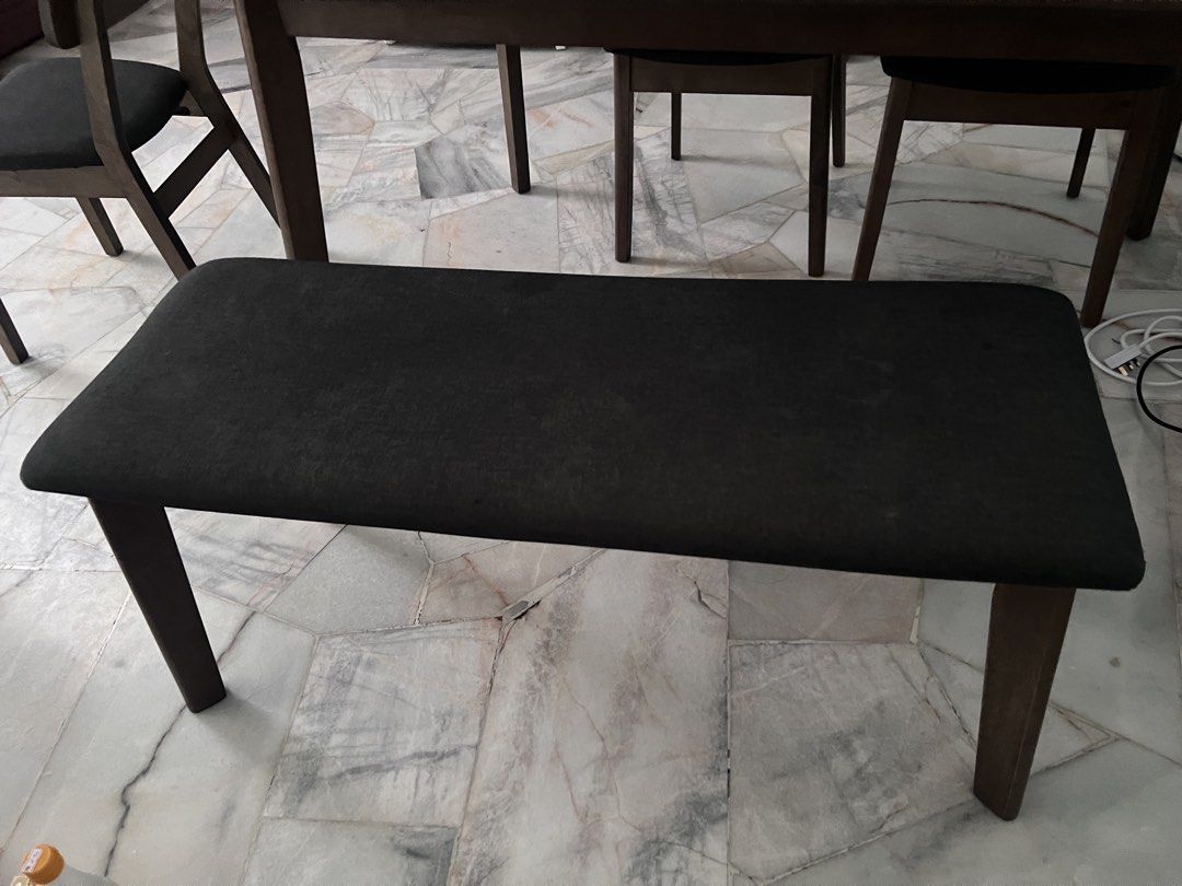 Dining Table (Category: Dinnerware & Cutlery) located in Seremban. Submitted by meenyda (Listing ID 1458924253, Image 2). Description: 🍽️ Dining Table Set 6-Seater Selling a wooden dining table set in good condition 🤎 * 6-seater dining set * Comes with 1 long bench + 5 chairs * Wooden table & chair frame * Black fabric cushions * Sturdy and comfortable * Minor signs of use.