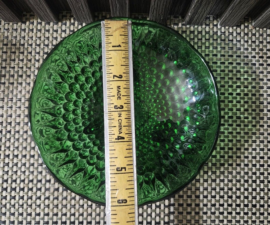 Emerald Green Glass Bowl with Embossed Pattern (Category: Other Kitchenware & Tableware) located in Rizal. Submitted by cherry_garcia (Listing ID 1458988924, Image 3). Description: - Beautiful emerald green glass bowl - Features a detailed embossed pattern all over - Scalloped edge rim - Measures approximately 6 inches in diameter - Stands about 2 inches in height - Ideal for serving snacks or as a decorative accent piece.