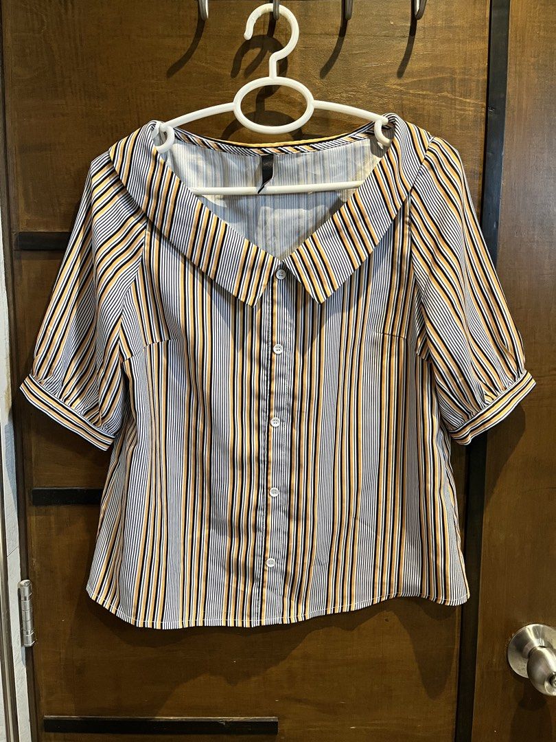 Emu Striped Button-Up Blouse with Collar (Category: Blouses) located in Las Pinas. Submitted by francesaly (Listing ID 1458974732, Image 1). Description: - Cute striped blouse from Emu - Features a wide collar and button-up front - Short puff sleeves - Vertical stripes in black, white, and orange-yellow - Versatile for casual or dressed-up occasions - Easy to pair with jeans or skirts.