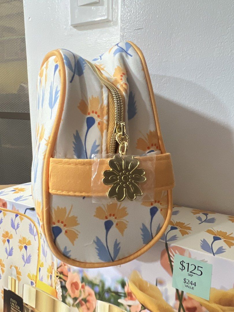 Estee Lauder Cosmetic Bag (Category: Makeup) located in Manila. Submitted by lunas_realm (Listing ID 1459069790, Image 2). Description: - Estee Lauder floral print cosmetic bag with a flower charm - Ideal for gifting or personal use.